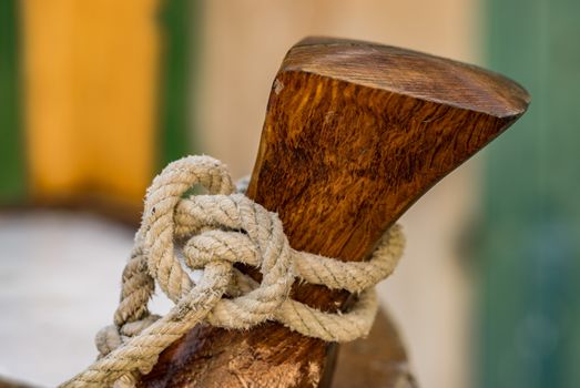 Close-up of rope cleat on boat deck 