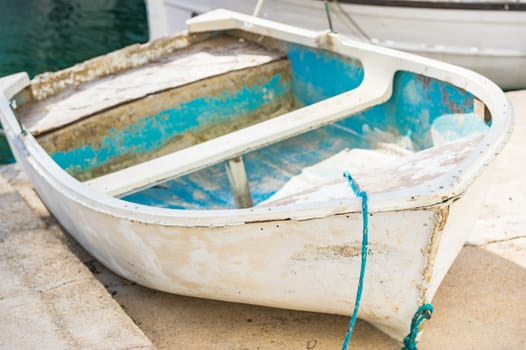 Close-up of old wooden rowboat at harbour