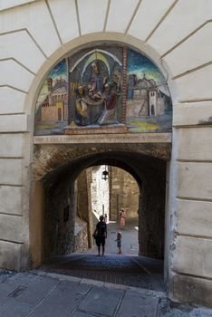 assisi,italy july 11 2020 :entrance to the street with painting that leads to the home of san francesco