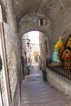 assisi,italy july 11 2020 :architecture of streets and buildings in the historic center of assisi