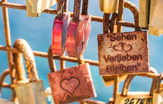 Many love padlocks hanging on fence