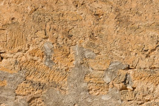 Old grunge damaged stone wall background texture, close-up