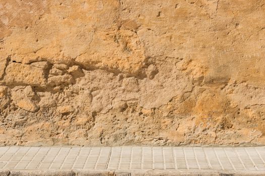 Old street wall background with sidewalk and copy space