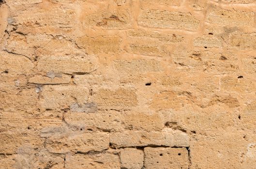 Vintage damaged stone wall background texture, close-up