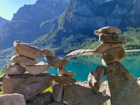 Stones stacked on top of each other with lake and mountain background