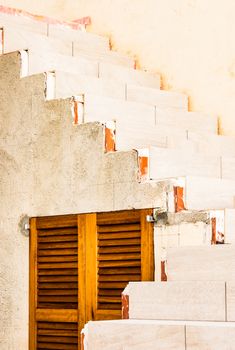 View of concrete staircase with brown wooden window