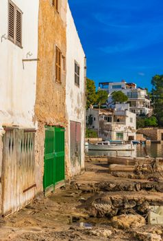 View of old fishing port in Cala Dor with boathouses on Mallorca island, Spain Mediterranean Sea