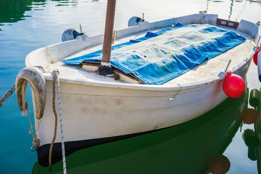 Close-up of old fishing boat anchored at harbor