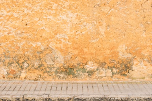 Grunge wall background texture with pavement and copy space