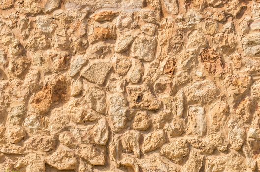 Natural brown stone wall background texture, close-up