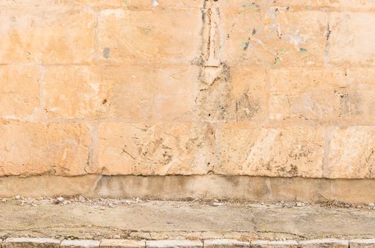Background scene of vintage dirty wall with sidewalk and copy space