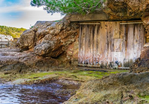 View of closed old wooden gate of boathouse
