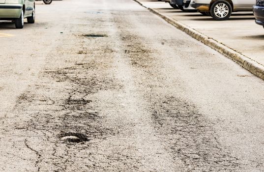 View of pot hole on asphalt road