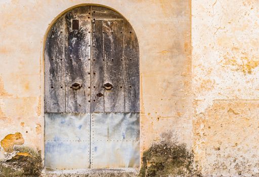 Vintage old wooden front door and damaged wall background