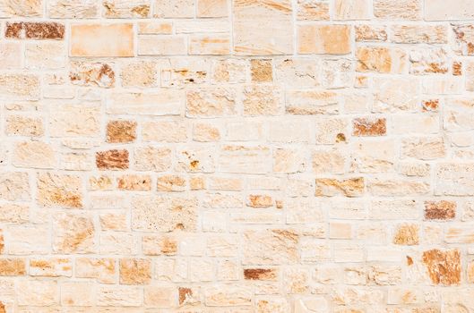 Natural light brown stone wall background texture, close-up