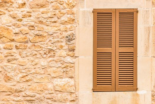 Old mediterranean window shutters and wall background 