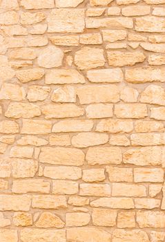 Natural brown stone wall background texture, close-up
