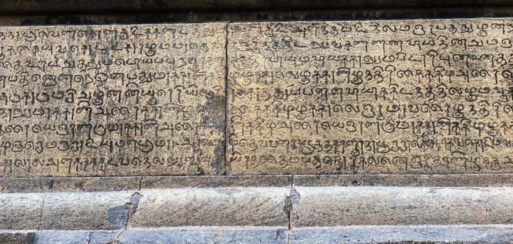 Ancient stone wall inscription in the temple