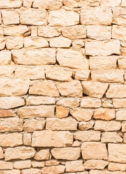 Rustic old light brown stone wall texture background structure