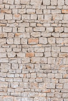 Old grey stone wall background texture, close-up