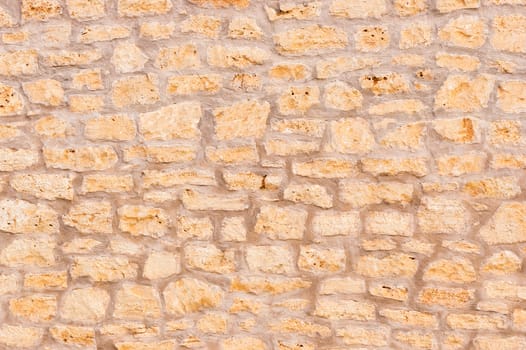 Vintage brown stone wall background texture, close-up

