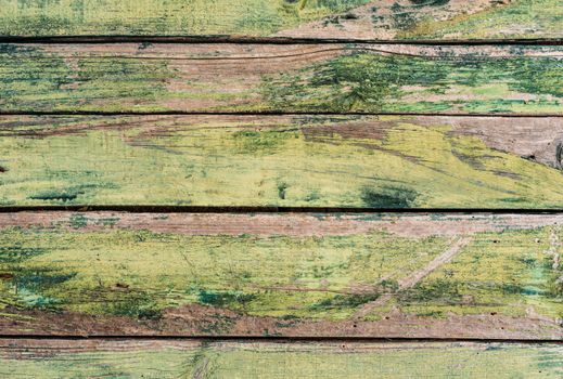 Weathered green painted wooden boards background texture with copy space