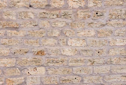 Old gray vintage stone wall background texture, close-up