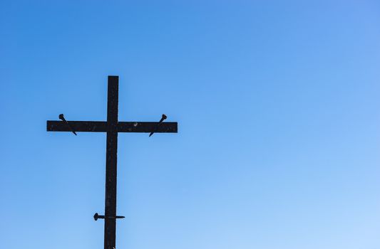 Cross against blue sky, religion christianity concepts background