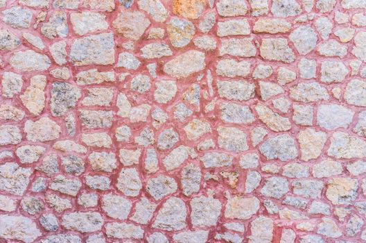 Stone wall with red cement background texture, structure close-up