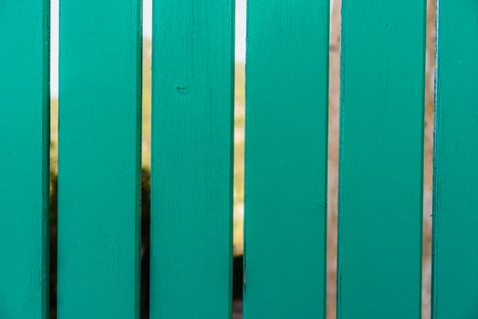 Close-up of green planks of wooden fence, background texture