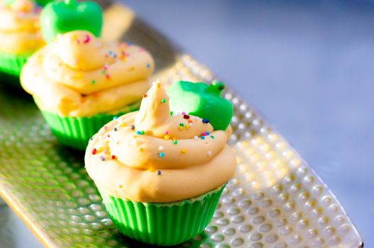 Delicious looking cupcake sot aps with green base and yellow lemon cream colorful sprinkles shot in golden sunrise light. Shows beautiful clean soap as a hobby or a home business for SLS free, paraben free artisanal handmade soaps