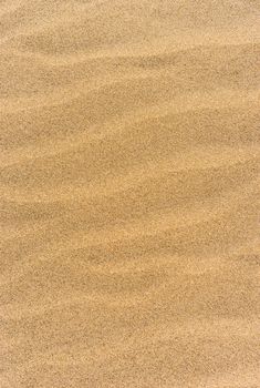 Wave pattern brown colored sand background texture