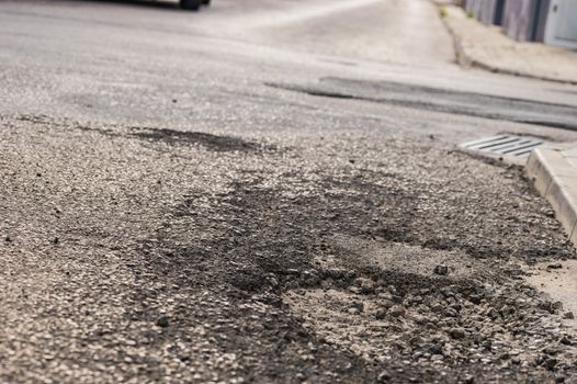 Close-up of pot hole on asphalt road