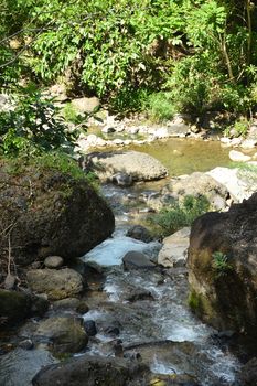 Daranak river current with surrounding rocks in Tanay, Rizal, Philippines.