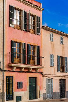 Mediterranean house with open window shuttes and balcony