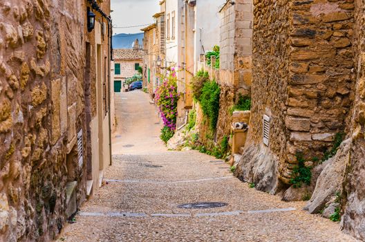 View of a narrow street in Capdepera, small old town on Mallorca, Spain