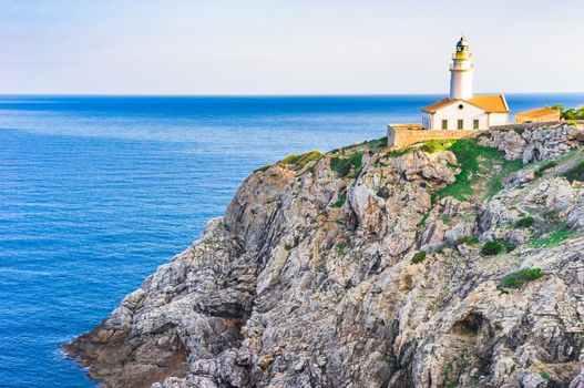 Beautiful view of the lighthouse at cliffs on the coast of Mallorca island, Spain Mediterranean sea