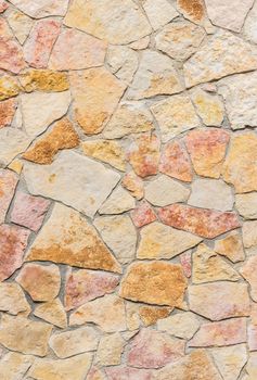 Rustic multicolored stone wall texture background structure