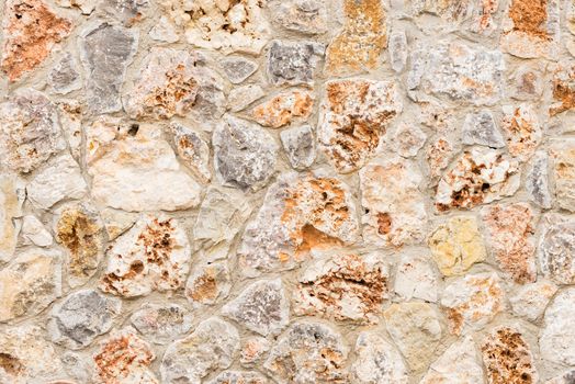 Rustic gray and brown stone wall background texture 