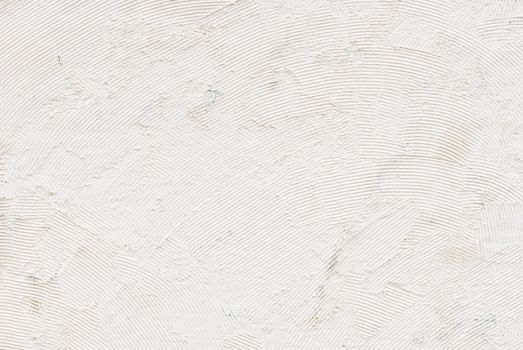 White raw plastered wall background texture with copy space