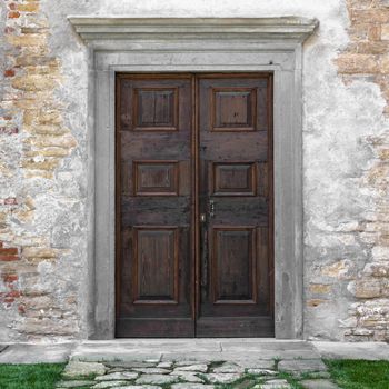 Classic wooden door of an old monastery, in Italy.