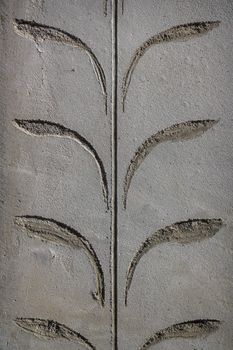 Fishes shape line of fresh concrete, on wall background.