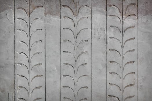 Floral decorations on concrete wall. Elegant background.