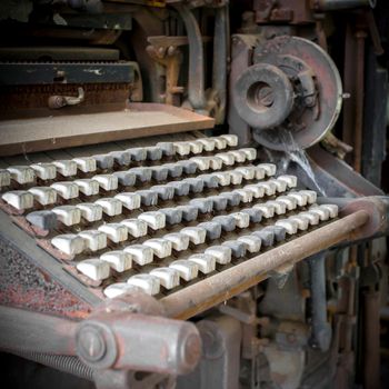 Old industrial machine with vintage keyboard. Extreme close-up and selective focus.