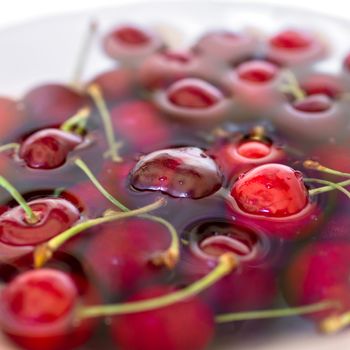 Washing ripe cherries close-up, organic food background.