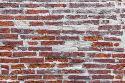 Old red brick wall with white concrete.