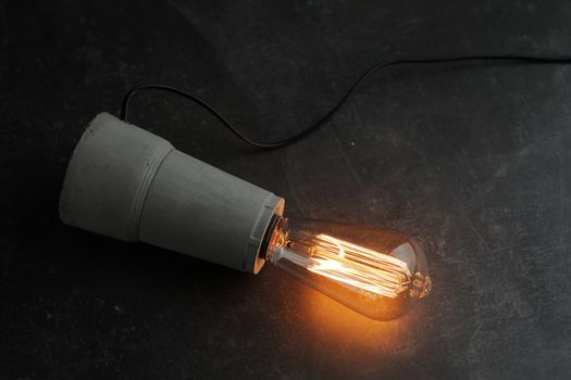 Retro lamp with Edison lamp on concrete. The concept is a good idea. High quality photo