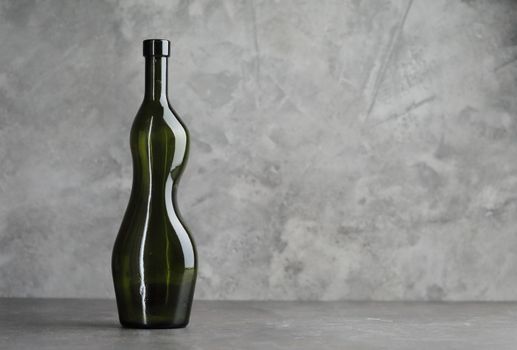 Wine bottle on a concrete background. Free space for inscription. High quality photo