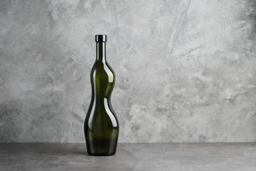 Wine bottle on a concrete background. Free space for inscription. High quality photo