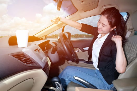 A tried women stretching her arms out to relax herself after a long day at work